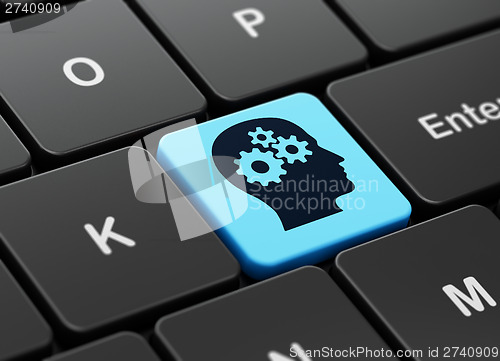 Image of Marketing concept: Head With Gears on computer keyboard