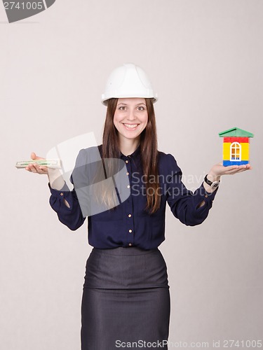 Image of Young beautiful girl offering to buy a house