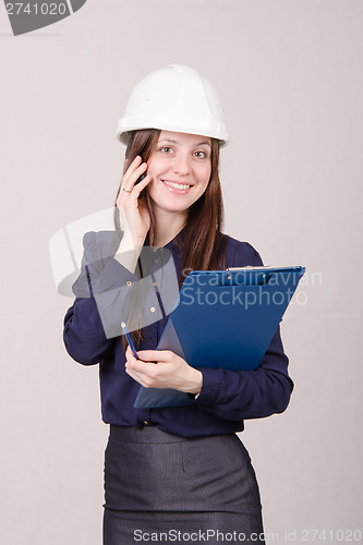 Image of Beautiful girl talking on phone with a client