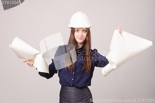 Image of Woman architect in helmet broke drawing