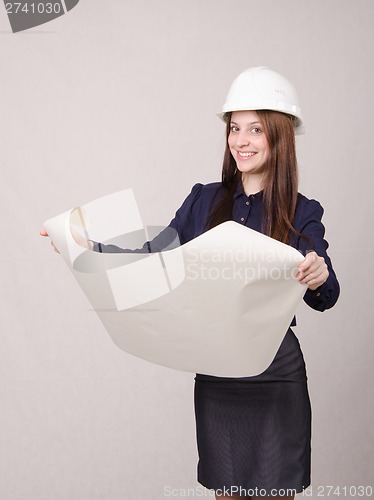 Image of Student project in helmet looks deploying hands drawing