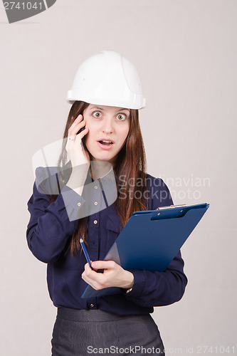 Image of Construction worker shocked by what he heard on phone