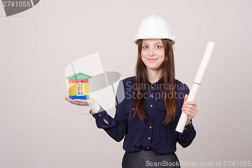 Image of Girl helmet with house worth and drawing in hands
