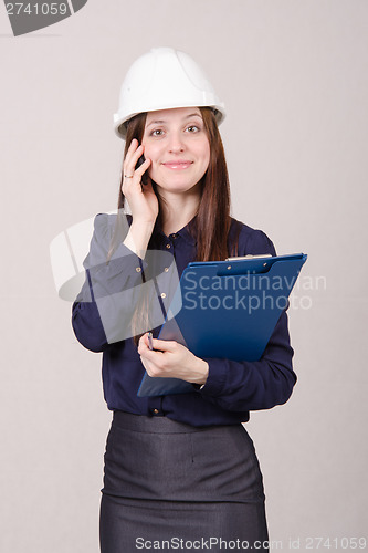 Image of Construction worker talking to a customer on phone