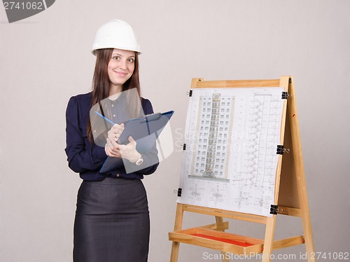 Image of Architect girl writes theses folder