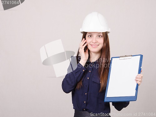 Image of Girl talking on the phone with a folder in hands