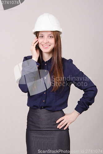 Image of Beautiful girl in helmet talking on phone