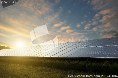 Image of solar panels under sky on sunset