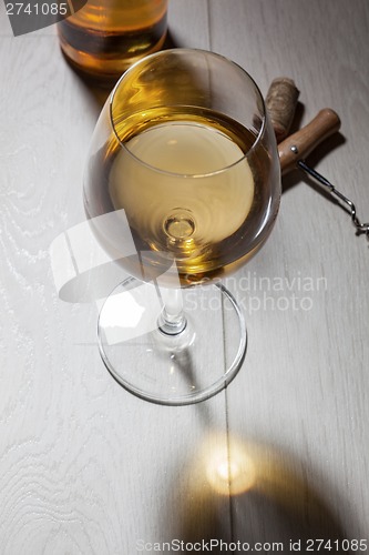 Image of Glass of white wine on wooden table