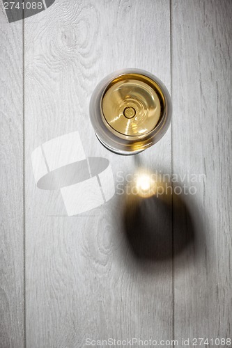 Image of Glass of white wine on wooden table