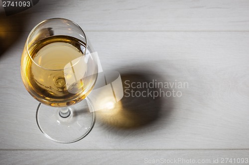 Image of Glass of white wine on wooden table