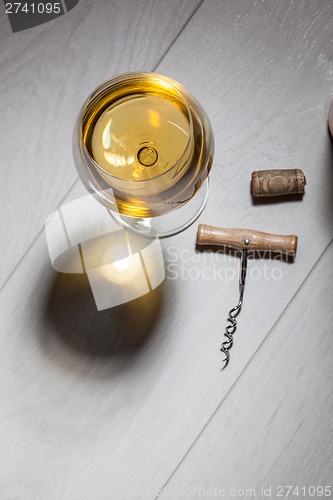 Image of Glass of white wine on wooden table