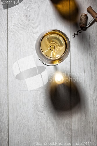 Image of Glass of white wine on wooden table