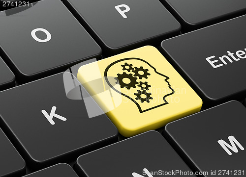 Image of Marketing concept: Head With Gears on computer keyboard