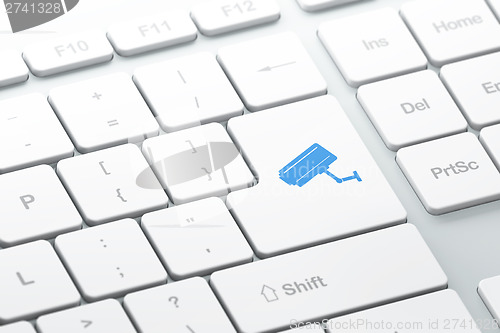 Image of Protection concept: Cctv Camera on computer keyboard background
