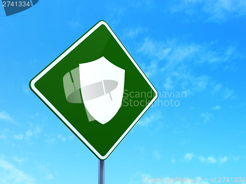 Image of Protection concept: Shield on road sign background