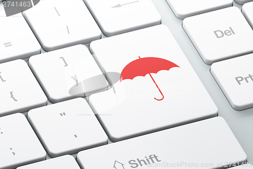 Image of Security concept: Umbrella on computer keyboard background