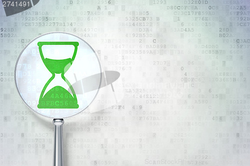 Image of Timeline concept:  Hourglass with optical glass on digital backg