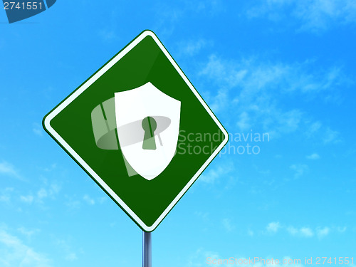 Image of Privacy concept: Shield With Keyhole on road sign background