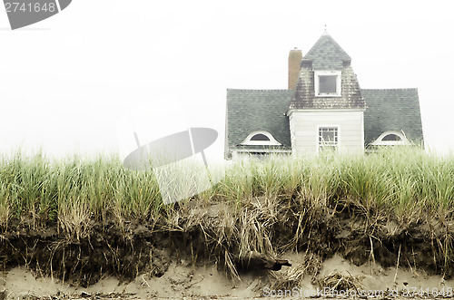 Image of Foggy beach house landscape