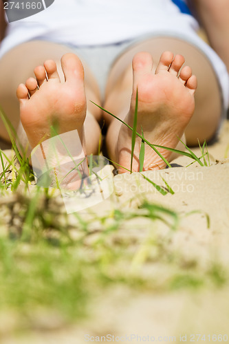 Image of baby foot on the beach