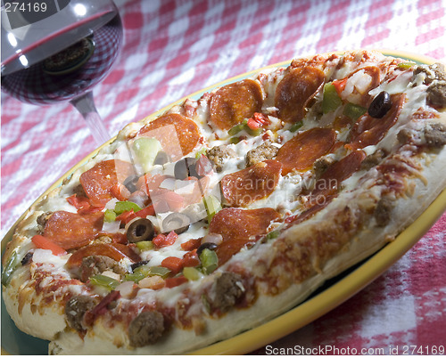 Image of supreme pizza and red wine