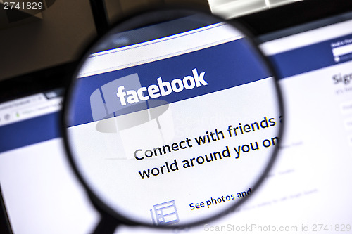 Image of Facebook website under a magnifying glass