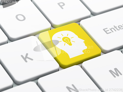 Image of Marketing concept: Head With Light Bulb on computer keyboard bac