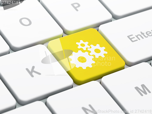 Image of Advertising concept: Gears on computer keyboard background