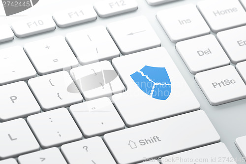 Image of Privacy concept: Broken Shield on computer keyboard background