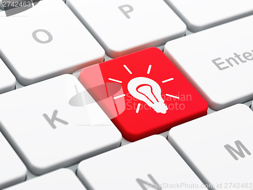 Image of Finance concept: Light Bulb on computer keyboard background