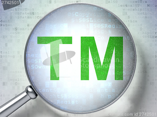 Image of Law concept:  Trademark with optical glass on digital background