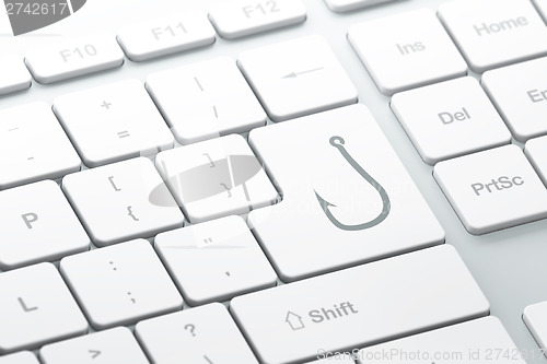 Image of Safety concept: Fishing Hook on computer keyboard background
