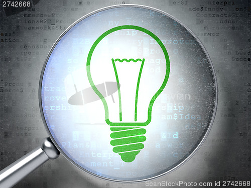 Image of Finance concept:  Light Bulb with optical glass on digital backg