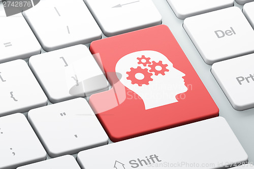Image of Business concept: Head With Gears on computer keyboard backgroun