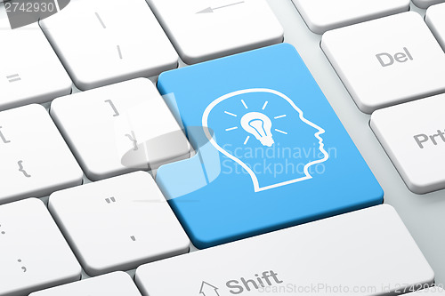 Image of Information concept: Head With Lightbulb on computer keyboard ba