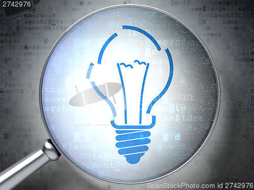 Image of Business concept:  Light Bulb with optical glass on digital back