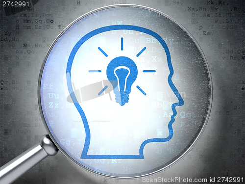 Image of Education concept:  Head With Lightbulb with optical glass on di