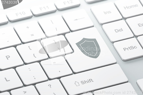 Image of Protection concept: Shield on computer keyboard background