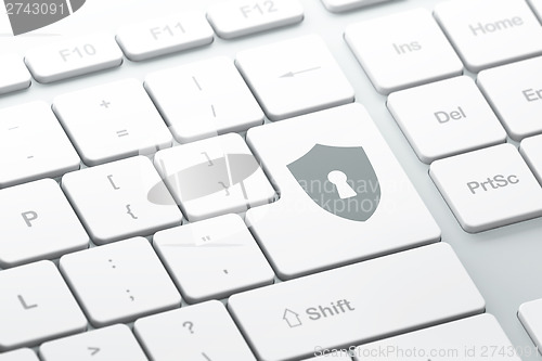 Image of Privacy concept: Shield With Keyhole on computer keyboard backgr