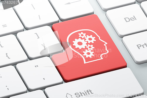 Image of Data concept: Head With Gears on computer keyboard background