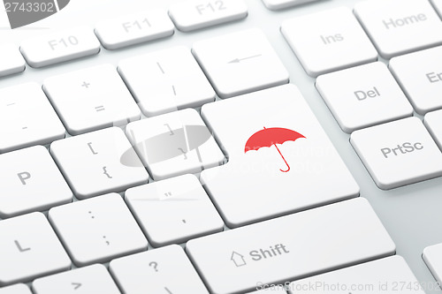 Image of Protection concept: Umbrella on computer keyboard background