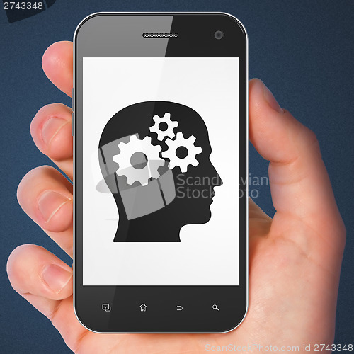 Image of Advertising concept: Head With Gears on smartphone