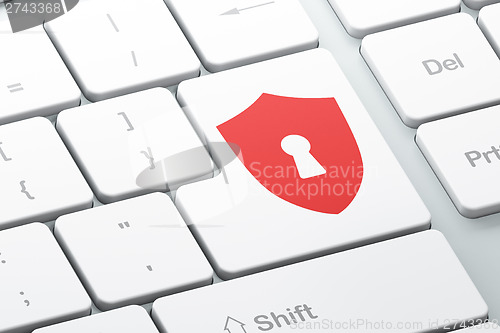 Image of Protection concept: Shield With Keyhole on computer keyboard bac