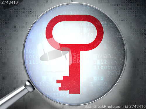 Image of Protection concept:  Key with optical glass on digital backgroun