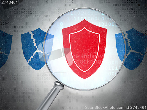 Image of Security concept: Shield with optical glass on digital backgroun