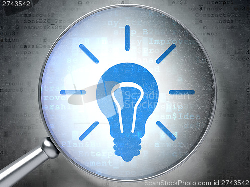 Image of Business concept:  Light Bulb with optical glass on digital back