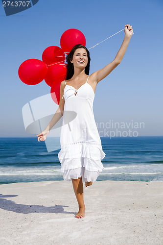 Image of Beautiful girl holding red ballons