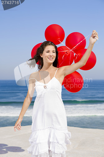 Image of Beautiful girl holding red ballons