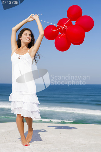 Image of Beautiful girl holding red ballons